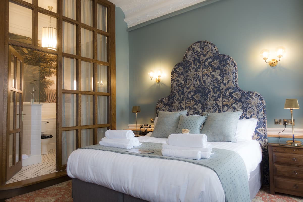 luxury suite | premium bedding, desk, laptop workspace, blackout curtains