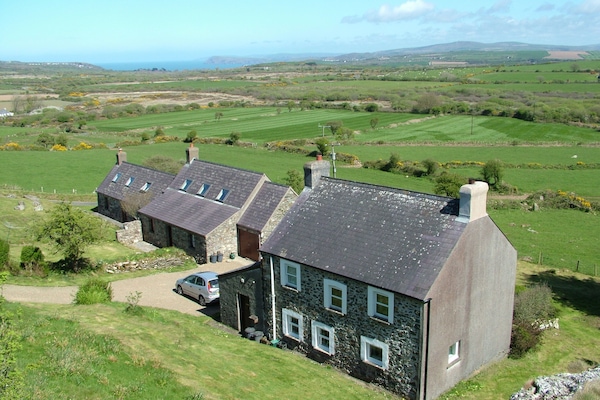 View from the Garn (rocky outcrop) of Garnllys house with two cottages nearby
