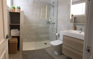Een douche, een haardroger, handdoeken, toiletpapier