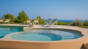 A pool with lounge chairs and a view of the sea. - TD Villa Ponente Luxury Villa with Sea View Pool (Capitolo)