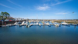 A marina with boats docked at piers, calm water, and a clear sky. - Forestside House - spacious house perfect for groups and families (Ballycastle)