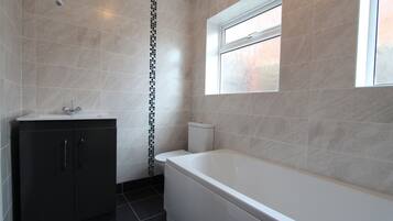 Bathtub, hair dryer, towels, soap