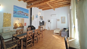 A rustic interior with a wooden ceiling, tiled floor, a dining area with wooden chairs, a TV, and a fireplace. - 🔑🔑🔑🔑Villa Can Mestreso New Suite Ibiza ETV1227E👍👍👍👍👍👍 (Ibiza)