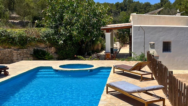 A swimming pool with a stone deck, lounge chairs, and a rustic fence. - 🔑🔑🔑🔑Villa Can Mestreso New Suite Ibiza ETV1227E👍👍👍👍👍👍 (Ibiza)