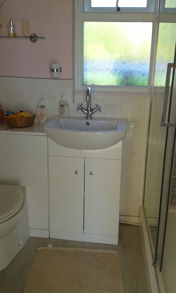 A bathroom with a sink, toilet, and shower. - Five Star SHACK
(Short Breaks Available) (Norfolk)