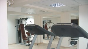 A gym with treadmills, weight machines, and a mirror. - Beautiful 2 bedroom apartment with attractive views  (Oriklini)
