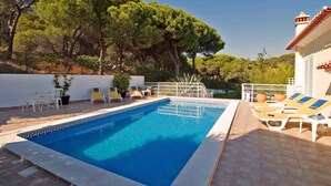 A rectangular swimming pool with a white border and a geometric pattern. There are lounge chairs and a table with chairs around the pool. -  Beautiful 5 bed detached villa, private pool, 700m from the beach - 66875/AL (Castro Marim Praia)