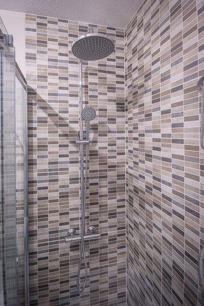 Shower, hair dryer, towels, toilet paper