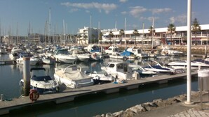 A marina with numerous boats docked, a clear sky, and buildings in the background. - Marina de Lagos Apartment  (Lagos)