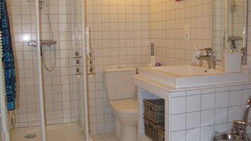 Combined shower/bathtub, hair dryer, soap, toilet paper