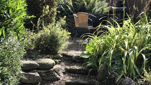 A garden with stone steps leading to a seating area.