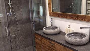 Bathtub, hair dryer, towels, toilet paper
