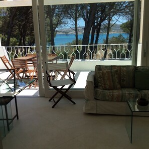 Enjoy the serene sea views and tranquil atmosphere from this spacious balcony, featuring a sofa, table, and chairs.