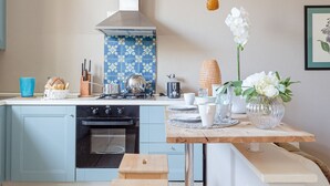 A kitchen with a stove, oven, and blue patterned backsplash. - CASA MARGHERITA Stunning view from Terrace (Lucca)