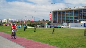 A cyclist on a red bike path with a modern building in the background. - Beach front apartment with superb sea view, 10 min. from Porto   (Vila Nova de Gaia)
