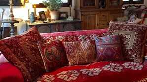A traditional room with a large bed, wooden beams, a cabinet with glass doors, and a window with curtains. - Country House and garden on Edge of Picturesque Village,LGBTQ+friendly (Bubion, Granada)