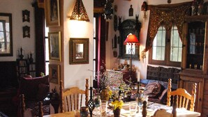 A cozy dining room with a wooden table, chairs, and a chandelier. - Country House and garden on Edge of Picturesque Village,LGBTQ+friendly (Bubion, Granada)