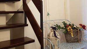 A staircase with wooden steps and a metal railing. - Attic in the center of Assisi (Assisi)