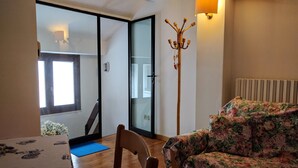 A bedroom with a bed, a chair, a table, a lamp, and a view of the outside. - Attic in the center of Assisi (Assisi)