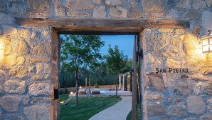 A stone entrance to a villa with a pathway leading to a seating area. - Walking Distance to Platanias Centre and the Beach! Heated pool! (Chania)