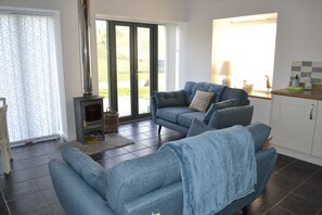 A living room with a sofa, a small table, and a fireplace.