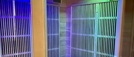 A sauna room with wooden benches and slatted walls.