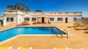 A two-story house with a swimming pool, outdoor seating, and a covered patio area. - Villa Bia OCV - Private Pool (Albufeira)