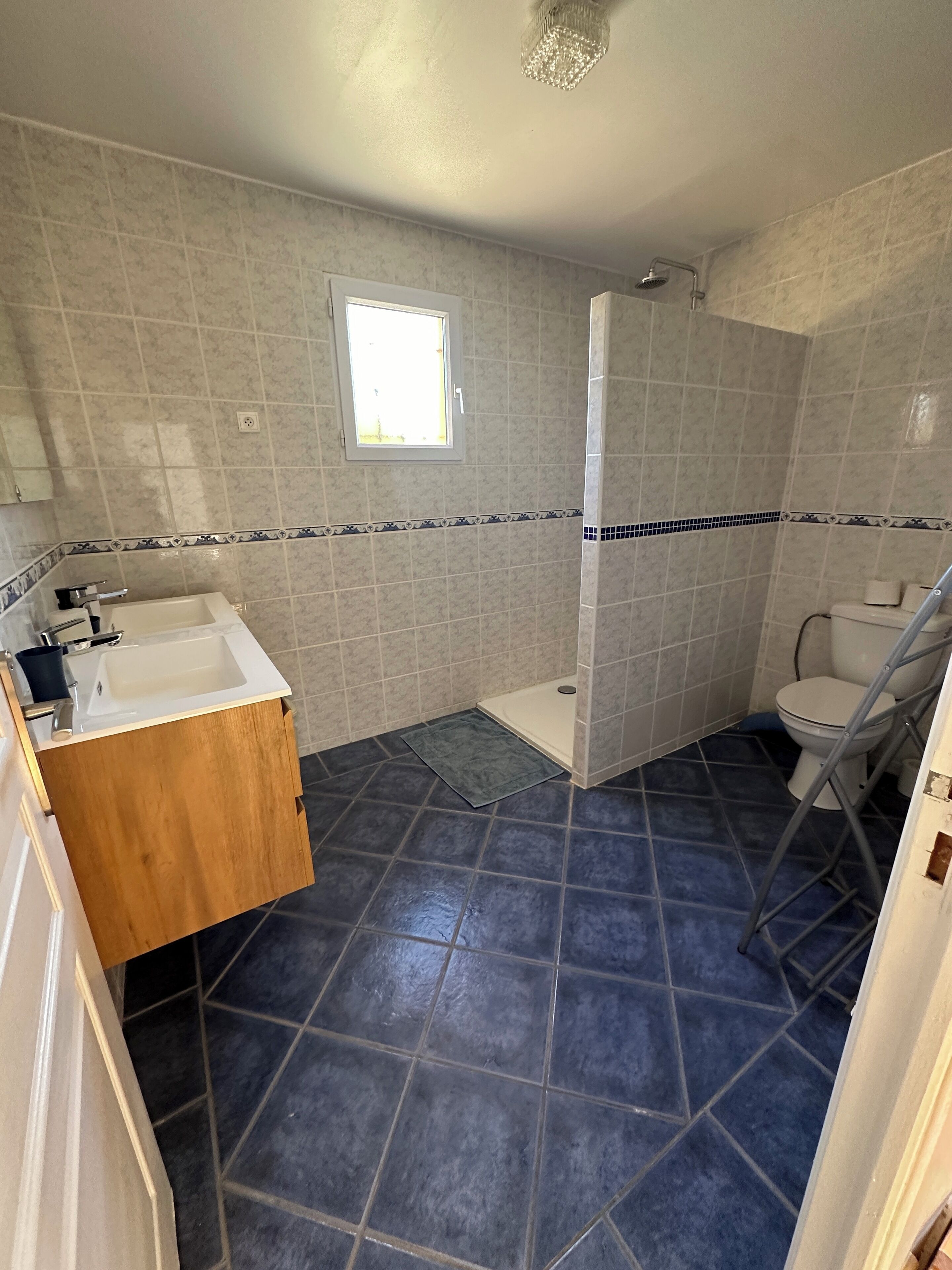 A bathroom with a shower, a toilet, and a sink.