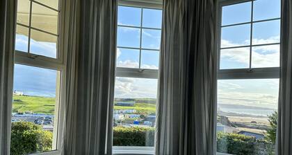Pendragon House Overlooks Crooklets Beach in Bude with parking for 5 cars.
