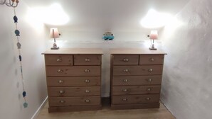 A room with two wooden dressers, a small toy van on the dresser, and two wall-mounted lamps. - Nature & tranquility, all year round, a piece of paradise in the Gorges du Tarn (Sainte-Énimie)