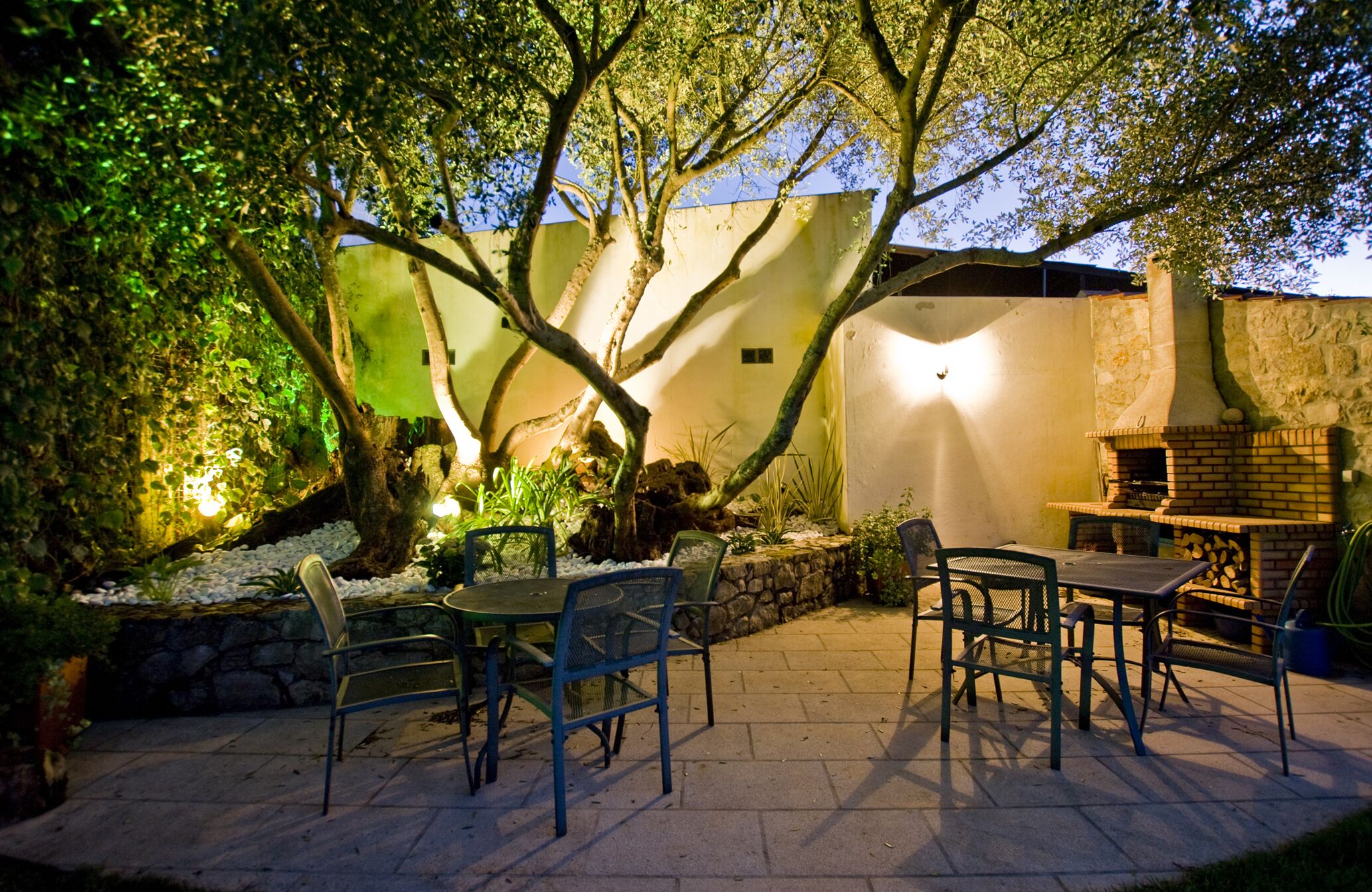 Barbecue area and 600 year old olive tree by night.