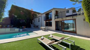 A modern two-story house with a swimming pool, outdoor seating, and a well-maintained garden. - Villa in Uptown Pollensa with spectacular views and private pool (Pollença)