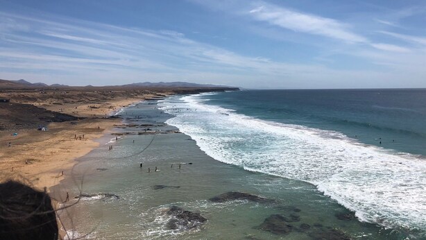 Paesaggio costiero con spiaggia e oceano.