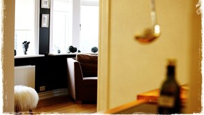 A room with a window, a radiator, a brown sofa, and a small stool. - Exceptional Luxury Apartment In 101 Reykjavik, The Centre Of Town
 (Reykjavik)