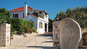 A villa with a stone pathway leading to the entrance, a red-tiled roof, and a stone sign with "VILLA EDEM" written on it. - Villa With Private Pool (Magganos)