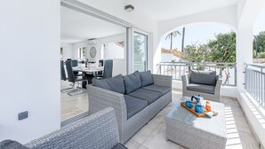 A modern outdoor living area with a sofa, chairs, and a coffee table. - Luxury villa with Private Pool Benalmadena (Benalmádena)