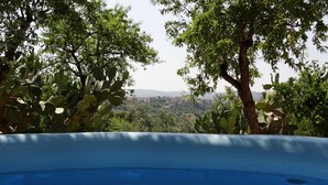 A hot tub with a clear view of a cityscape in the background.