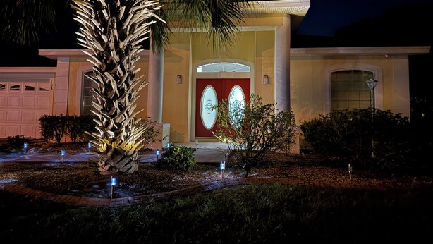 A modern house with a red door, a garage, and a well-lit entrance. - Executive Villa with lake views,  south facing pool 4 bed 3 bath. Games room (Davenport)