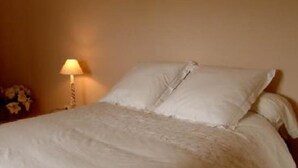 A neatly made bed with white linens in a room with a single bedside lamp. - House / Villa - Coustouge (Coustouge)