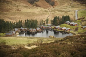 A lakeside lodge with multiple cabins, a central building, and a surrounding natural landscape. - Na Craigean Lodge - Glengoulandie (by Aberfeldy, Perthshire)