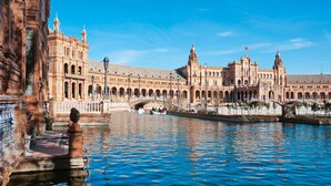 A historic building with a large courtyard and a canal.