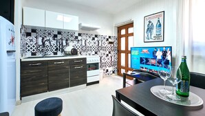 A modern kitchen with dark wooden cabinets, a white countertop, and patterned backsplash tiles. - Design seashell design (San Pellegrino terme bergamo)