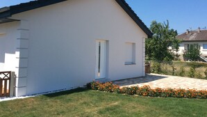 A single-story house with a white exterior, a dark roof, and a small front porch. - 3-bedroom house near Colmar (Bennwihr)