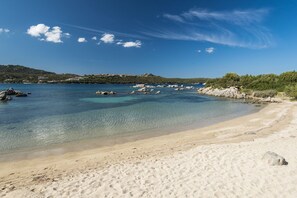 A beach with clear water, sandy shore, and rocky outcrops. - Villaggio S'abba e Sa Pedra - S'ABBA DI SU (Golfo Aranci)