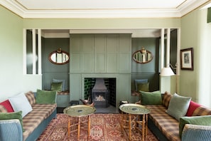 Drawing room: inglenook with open fire and 42" TV