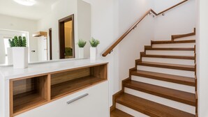 A staircase with wooden steps and a wooden handrail, leading to an upper floor. - New Villa for 8 people with spectacular view (Potpican)