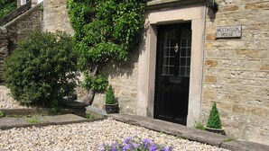 A stone building with a black door and a sign that reads "WESTBROOK HOUSE". - Traditional Dales Cottage with stunning views,  (Newbiggin, Bishopdale)