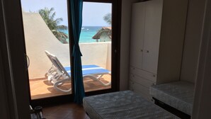 A room with a bed, a chair, and a view of the ocean. - Apt71 Porto Antigo 2 Two Bed Penthouse with Shared Pool and Panaromic Sea Views. (Santa Maria)