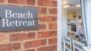 A brick wall with a sign reading "Beach Retreat."