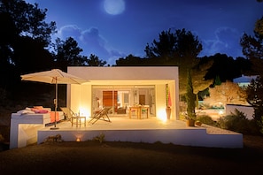 Enjoy the evening outdoors in this inviting patio area with a comfortable seating arrangement and table.